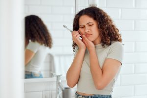 Woman Experiencing Dental Emergency